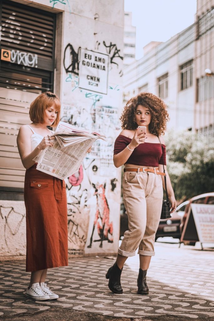 服を綺麗にきこなすには綺麗に痩せる・綺麗に筋肉をつける photo of one woman reading a newspaper and another holding 2408045 683x1024 - 服を綺麗にきこなすには綺麗に痩せる・綺麗に筋肉をつける